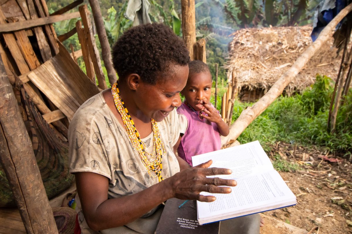 1000x1000-A woman in Daboto reads the New Testament in the Moi translation, her mother tongue.