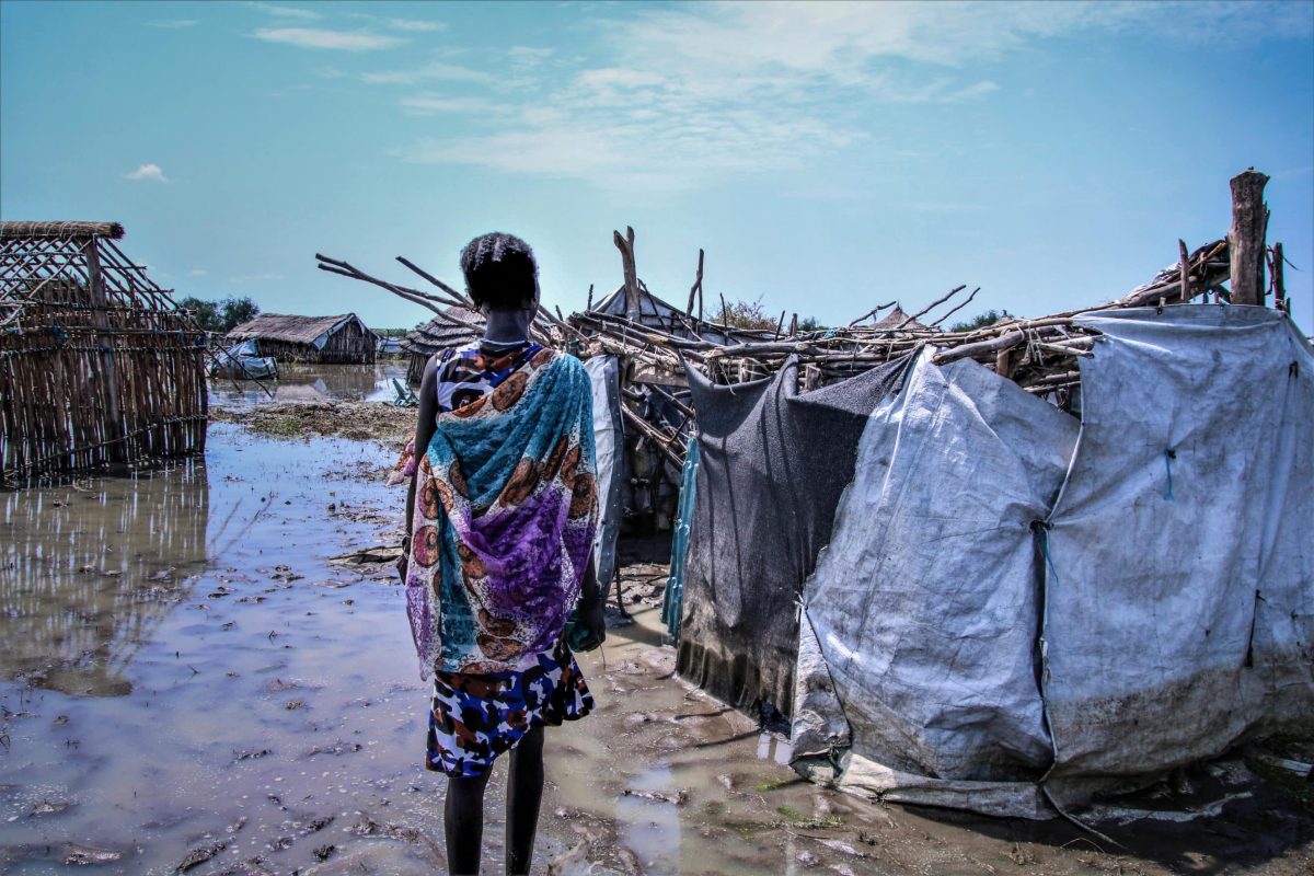 Lakchia, a 30-year old mother of 6 children in front of her flooded house in Pibor.
From September to November 2020, Pibor has been badly hit by flooding, which followed fighting earlier in the year and last years flooding. Lakchia is one of the many people affected by the flooding.
The regions floods exacerbate layers of pre-existing vulnerabilities intercommunal violence, intensifying economic setbacks, an uptick of food insecurity, and rising health risks. As the rainy season is nearing its end (November 2020), flood waters are gradually subsiding in several places. Yet, the impact of the current flooding on peoples lives will be felt long after the water levels have retreated. People have lost their houses and livestock, crops have been washed away, and health facilities have been destroyed; we fear that diseases will increase as a result.
A partner organisation raised concern regarding a measles outbreak in late September with more than 300 suspected casesan alarming rise to a vaccine preventable and potentially deadly disease.
In response to the deteriorating health situation, Medair mobilised an Emergency Response Team to conduct a mass measles vaccination campaign for children under five years of age in the Greater Pibor Administrative Area. Teams walked through the water and sticky mud, and travelled by boat and canoe to reach affected communities, of which many clustered on small islands surrounded by the flood waters. 
Lakchias story is available: .https://app.box.com/s/keg9cil6od5xxfs8a63k6i7st6j9x5vz
A few quotes from Lakchia: .Last year, my husband passed away. He was killed in the fighting. Our cows were taken and my husband was killed. The brother of the husband is in the place where the cases are and I dont receive support from them. The cows were taken in the fighting.
I go to the woods, to collect firewood and sell that in the market. The money is not enough for the children (to feed them). With selling firewood, I earn 500-600 South Sudanese Pounds. Some days, we can, if I have been able to collect firewood. If there is no firewood, we dont eat. We are eating one meal a day. Hunger is our problem.
Before the floods had arrived, I had planted sorghum. But all of the crops have been destroyed by the water. My house is destroyed as well. The house has fallen down. [Points to her new house]. This is not my place. This is someone elses plot. When I go back, where should I sleep? I dont know.
Im getting worried about the fighting. Last time I heard is that the war will continue. I dont know why the fighting happens. Where do I take the children?
When the floods came, I left my belongings and when I went back, I found them stolen."
Thank you for the measles vaccine.